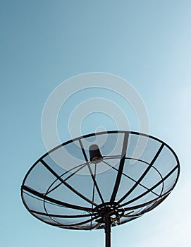 Single satellite dish with blue sky background