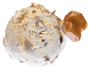 Single scoop of vanilla - caramel - brownie ice cream with caramel pieces from above isolated on white background