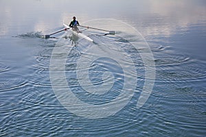 Single scull rowing competitor, rowing race