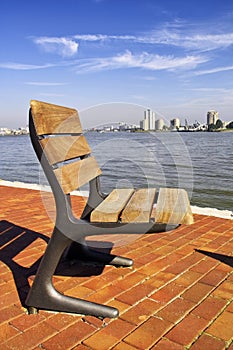 A single seat on the river bank in Rotterdam