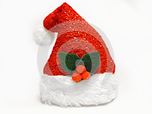 Single shimmering Santa Claus red hat with mistletoe isolated on white background