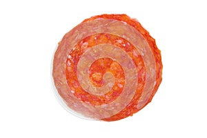 Single slice of salami over white photo