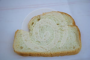 Single slice of white bread on clean background for breakfast and food preparation concept