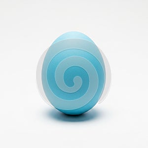 A Single Light Blue Easter Egg Centered on a White Background pastel