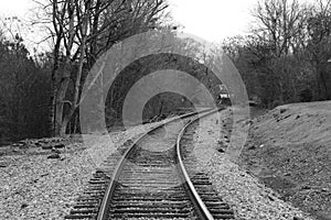 single spooky train tracks leading into the distance in black and white