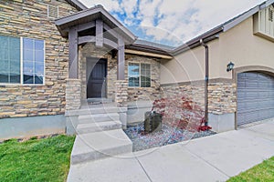 Single storey house with stone brick wall and portico and porch at the facade