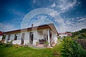 Single storey private house wide angle image, hdr colors, outside view with garden in summer