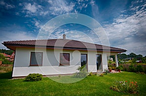 Single storey private house wide angle image, hdr colors, outside view with garden in summer