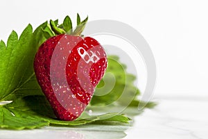 Single Strawberry standing on end with Leaves
