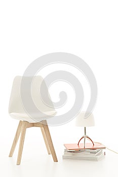 Single stylish modern white chair with a lamp