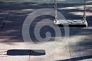 Single swing seat and shadow in playground