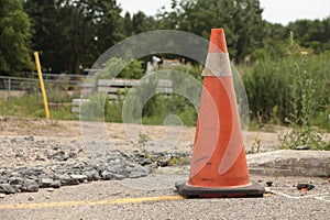 single tall beat up marked pylon with black bottom and thick white stripe at top