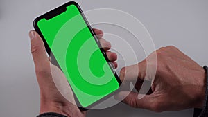 Single Tapping and Holding a Green Screen Smartphone