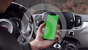 Single Tapping and Holding a Green Screen Smartphone in a Car