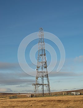 Single telecommunicatin tower/ mast against blue sky