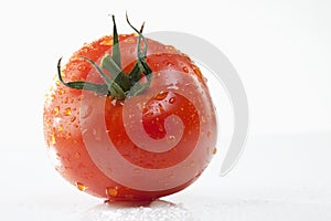 Single tomato with water droplets, close-up
