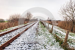 Single-track rails in a winter landscape covered with a layer of snow