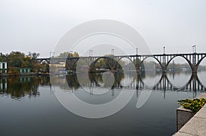 Single-track railway arch bridge in fog