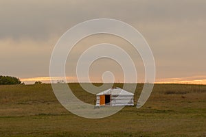 Single Traditional Nomadic House on Grassland Horizon at Sunset