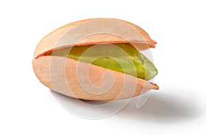 Single Turkish red pistachio, peeled green nut visible, isolated on white background