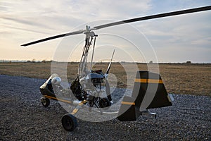 Single ultralight homemade gyroplane stands at the airdrome