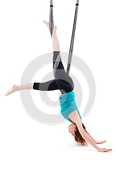 Single upside down woman doing aerial yogawith a hammock