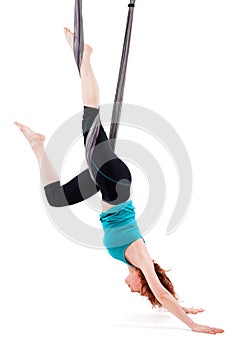 Single upside down woman doing aerial yogawith a hammock