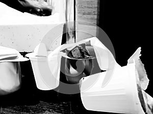 Single use coffee creamer cups as trash on counterspace