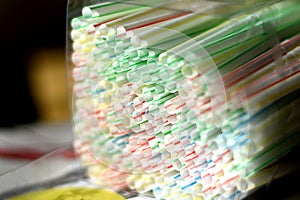 Single use disposable throwaway white striped plastic straws