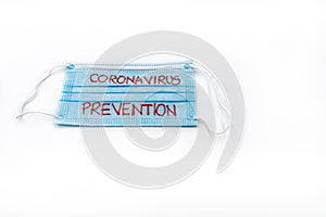 Single use medical face mask with handwritten message Coronavirus Prevention isolated over white background, coronavirus