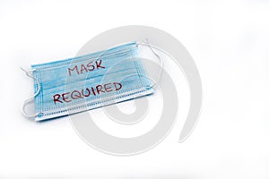 Single use medical face mask with handwritten message Mask Required isolated over white background photo