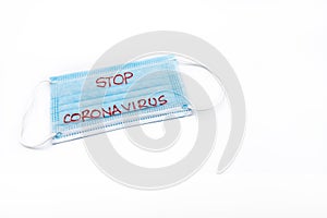 Single use medical face mask with handwritten message Stop Coronavirus isolated over white background