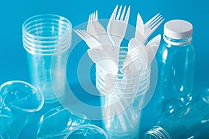 Single use plastic cups, forks, spoons. concept of recycling plastic, plastic waste