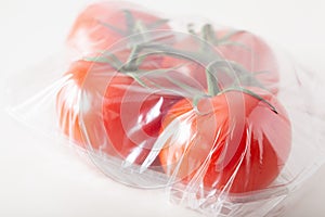 Single use plastic packaging issue. tomatoes vegetables in plastic bag