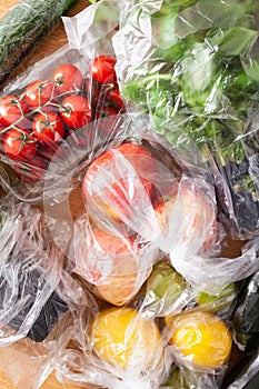 Single use plastic waste issue. fruits and vegetables in plastic bags