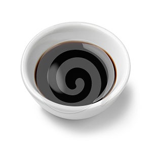 Single white bowl with Balsamic vinegar, aceto balsamico, on white background close up photo