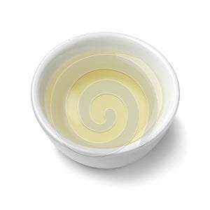 Single white bowl with natural vinegar on white background close up