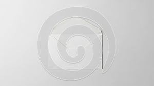 Single white envelope on plain background