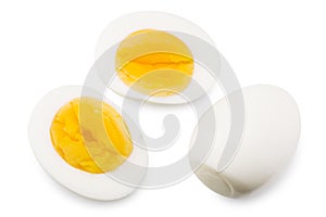 Single whole boiled egg with halved egg isolated on a white background. Top view