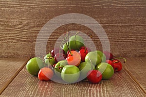 Single whole fresh green Can Erik plum and cherry close up isolated on dark background