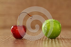 Single whole fresh green Can Erik plum and cherry close up isolated on dark background