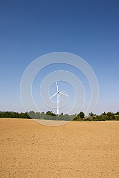 Single wind turbine with blue sky