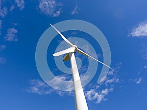 Single wind turbine in blue sky