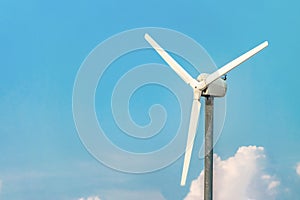 Single wind turbine closeup on the blue sky background