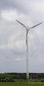 single wind turbine on a piece of meadow