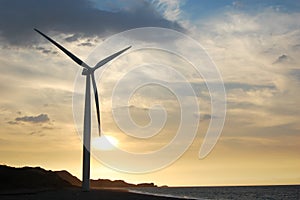 Single wind turbine at sunset