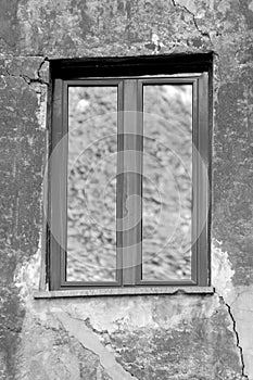 Single window closeup in a cracked wall photo