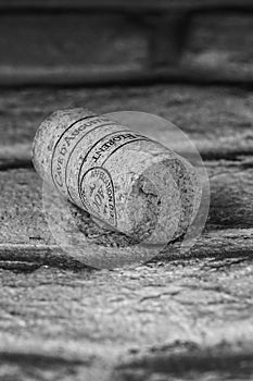 Single wine cork on gray background