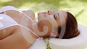 Single woman laying down in outdoor beauty spa