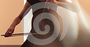 Single woman playing the cello, close-up and medium close-up, cello bow and strings